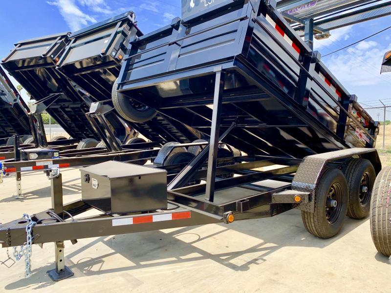 A row of black R & J Trailers Dump Trailer trailers fully extended in a concrete lot.