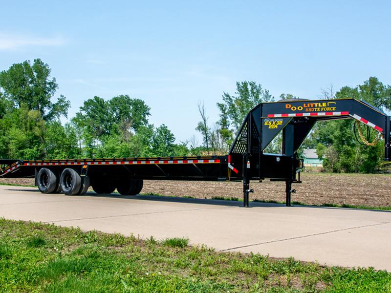 A 2024 Doolittle Trailers Brute Force 102 TA 14,000 lbs. parked in front of green grass